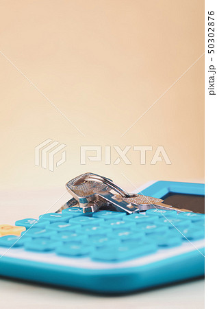 bunch of key on calculator over wooden background 50302876