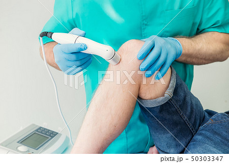 Close up Young man receiving laser or magnet 50303347
