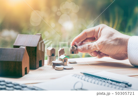 House placed on coins Men's hand is planning House placed on coins Men's hand is planning 50305721