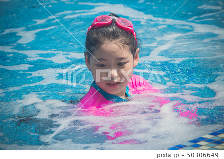 Asian cute little girl has feeling funny and enjoy Asian cute little girl has feeling funny and enjoy 50306649