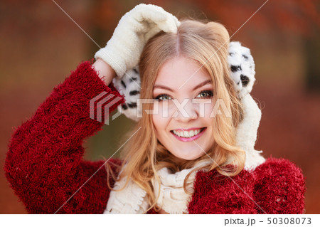 Pretty gorgeous woman in earmuffs. 50308073