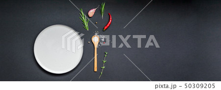 Empty plate with greens herbs and spices around Empty plate with greens herbs and spices around 50309205
