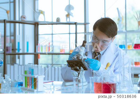 Scientist adjusting microscope for experiment. 50318636