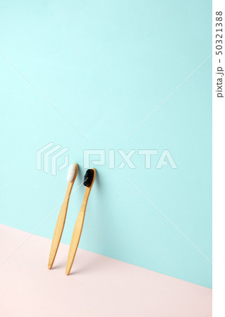 Bamboo teeth brush on minimalistic backgroud. zero Bamboo teeth brush on minimalistic backgroud. zero 50321388