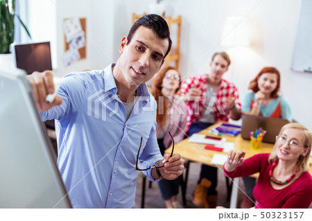Handsome young man looking at the whiteboard Handsome young man looking at the whiteboard 50323157