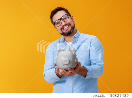 concept of Finance and business. man with piggy concept of Finance and business. man with piggy 50325489