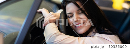 Happy customer woman buying a new car in dealeship center Happy customer woman buying a new car in dealeship center 50326000
