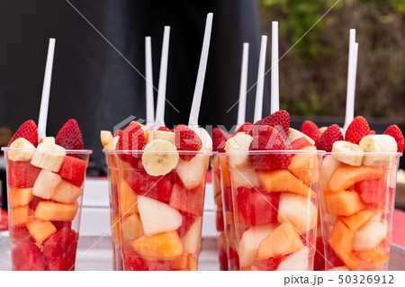 Mixed Fruit Salad arranged in plastic cups on a market stall. Mixed Fruit Salad arranged in plastic cups on a market stall. 50326912