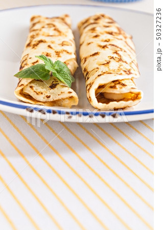 thin pancakes rolled crepes mint on a plate with 50327236