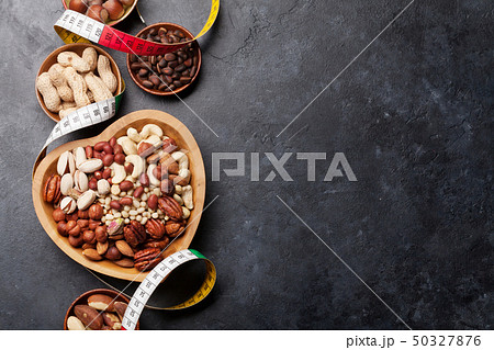 Various nuts selection on stone table Various nuts selection on stone table 50327876