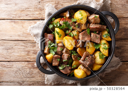Traditional fried potatoes with pork and mushrooms Traditional fried potatoes with pork and mushrooms 50328564