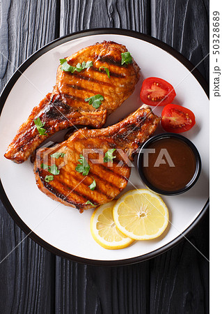 Barbecue pork chop in a tamarind sauce, with lemon 50328689
