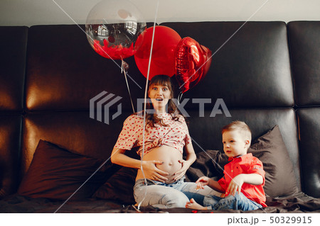 Elegant mother with little son in a bed 50329915