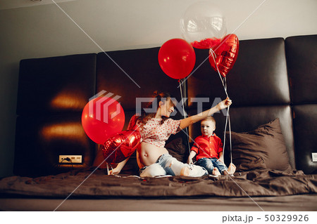 Elegant mother with little son in a bed Elegant mother with little son in a bed 50329926