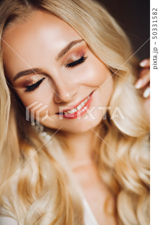 Sensuality smiling young blondie with closed eyes. 50331582