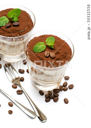 two portions Classic tiramisu dessert in a glass isolated on a white background 50332556