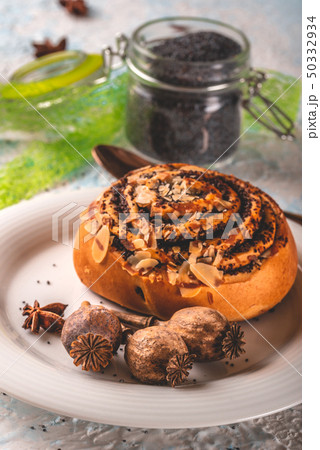 Few poppy heads on white plate with sweet baked Few poppy heads on white plate with sweet baked 50332934