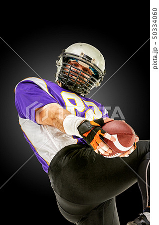 American football player in action with ball 50334060