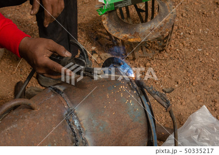 Welder is welding metal piping in construction 50335217