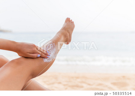 Young woman is having rest on the sunbed at the 50335514