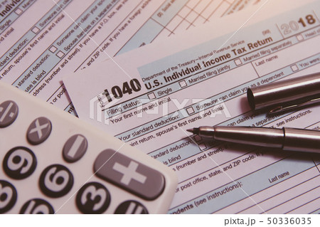 Tax season. calculator, pen on 1040 tax form Tax season. calculator, pen on 1040 tax form 50336035