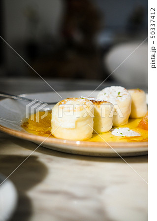 Cottage cheese pancakes with orange jam 50337412