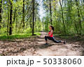 Fitness woman doing leg stretching in summer forest 50338060