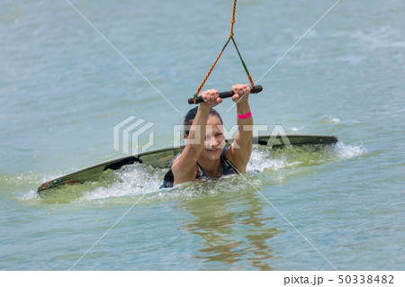 Woman study wakeboarding on a blue lake 50338482