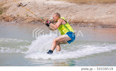 Man study wakeboarding on a blue lake Man study wakeboarding on a blue lake 50338519