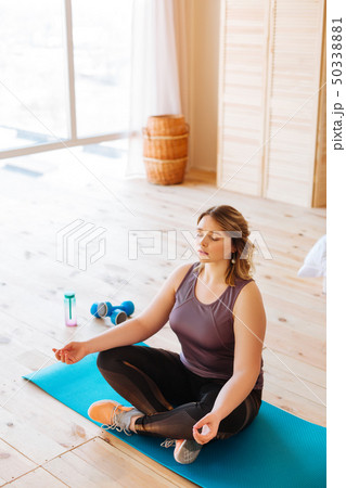 Top view of a nice young woman practicing yoga Top view of a nice young woman practicing yoga 50338881
