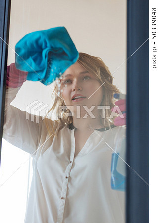 Beautiful nice woman looking at the window 50339048