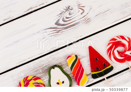 Delicious lollipops on wooden background. Delicious lollipops on wooden background. 50339877