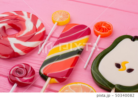 Assorted lollipops on color background. 50340082