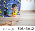 Happy little boy having fun with a play tent at 50343012