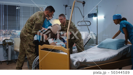 Injured soldiers in hospital among doctor and nurse Injured soldiers in hospital among doctor and nurse 50344589
