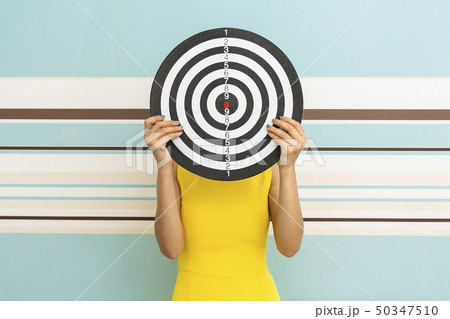 Goals concept with young woman holding target on Goals concept with young woman holding target on 50347510