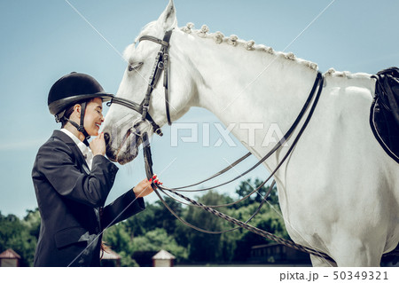 Nice beautiful woman standing in front of her horse 50349321