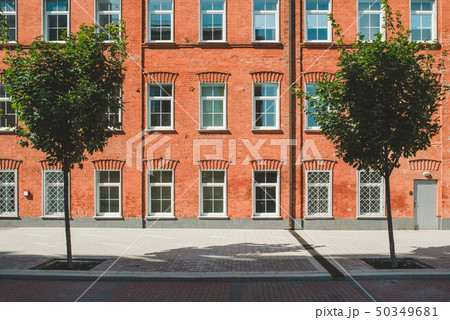Office building in loft style. Large Windows. Red brick wall. Green bushes on the middle. Flat Office building in loft style. Large Windows. Red brick wall. Green bushes on the middle. Flat 50349681