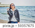 Beautiful young redhead woman staying at the beach 50357675