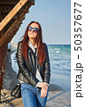 Beautiful young redhead woman staying at the beach 50357677