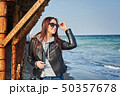 Beautiful young redhead woman staying at the beach 50357678