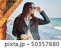 Beautiful young redhead woman staying at the beach 50357680