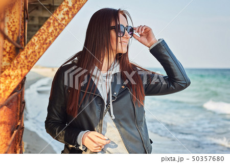 Beautiful young redhead woman staying at the beach 50357680