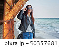 Beautiful young redhead woman staying at the beach 50357681