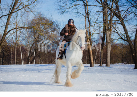 Man in suit of ancient warrior riding big white horse 50357700