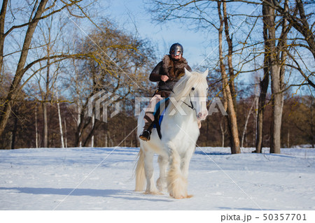 Man in suit of ancient warrior riding big white horse Man in suit of ancient warrior riding big white horse 50357701