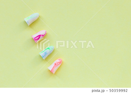 Earplugs on the yellow background 50359992
