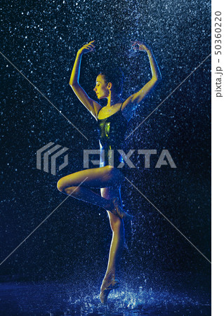 Two young female ballet dancers under water drops Two young female ballet dancers under water drops 50360220