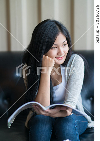 Portrait of woman reading a book at coffee cafe Portrait of woman reading a book at coffee cafe 50360726