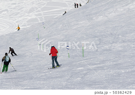 Skiers and snowboarders downhill 50362429